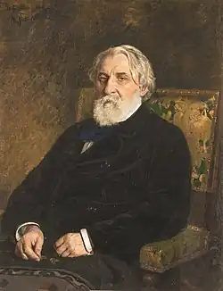 Oil painting of bearded man with white hair, seated in an armchair and dressed in a dark coat