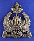 NCO's cap badge for the peaked service dress hat from the 2nd issue (with motto) c. 1920