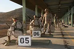 A USMC marksmanship instructor wearing an elephant hat at a firing range at Marine Corps Air Station Miramar in 2009