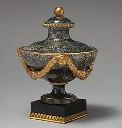 Ornate neoclassical vase with shiny, mottled glaze