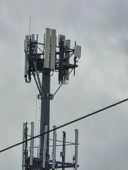 A close-up photo of the antennas and remote radio units on a monopole cell tower.
