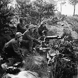 British Vickers gunners in action in the Netherlands during Operation Market Garden. All are wearing the Mk III Turtle helmet.