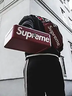 “Hypebeast” streetwear in Vienna, 2017, featuring Supreme-branded accessories and track pants, 2017