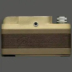 Back view of the camera, displaying the two-tone brown color and viewfinder.