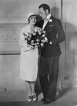 Black and white photograph of a man and woman in 1920s formal attire