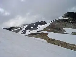 Rugged landscape of rubble covered with snow on a cloudy day.