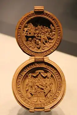 Prayer nut (WB.238) with upper Magi and a lower Pieta with Saint James the Greater, Saint Ursula and inscriptions, c. 1510–1525, British Museum[29]