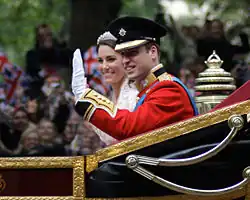 Prince William and Catherine Middleton waving in a carriage during their wedding