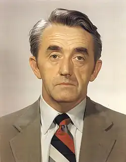 Headshot of a suited Buckley