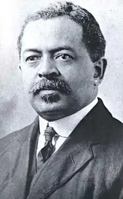 Formal portrait photograph of an African American man, wearing a suit
