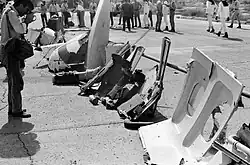 Wreckage of the aircraft. A window frame and other parts are visible.