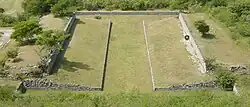 One of the ballcourts at Xochicalco. Note the characteristic -shape, as well as the rings set above the apron at center court. The setting sun of the equinox shines through the ring.[11]