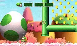 A horizontal rectangular video game screenshot that is a digital representation of a pink grassland with large hills in the background. A green bipedal dinosaur holds a giant white egg with green dots that fills a third of the screen. A reticle is aimed at a group of green pipes on the other half of the screen, and a dotted line is drawn from the bottom of the egg to the reticle.