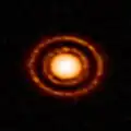 Protoplanetary disc AS 209 nestled in the young Ophiuchus star-forming region.[23]