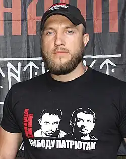 Ruf in front of "Дух Нації&nbsp;[uk]" (Nation's spirit) flag.