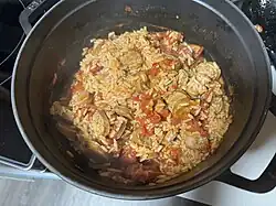 Cooked Zatarain's jambalaya with tomatoes and sausage in a pot.