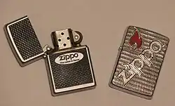 Two Zippo lighters, one open, one closed